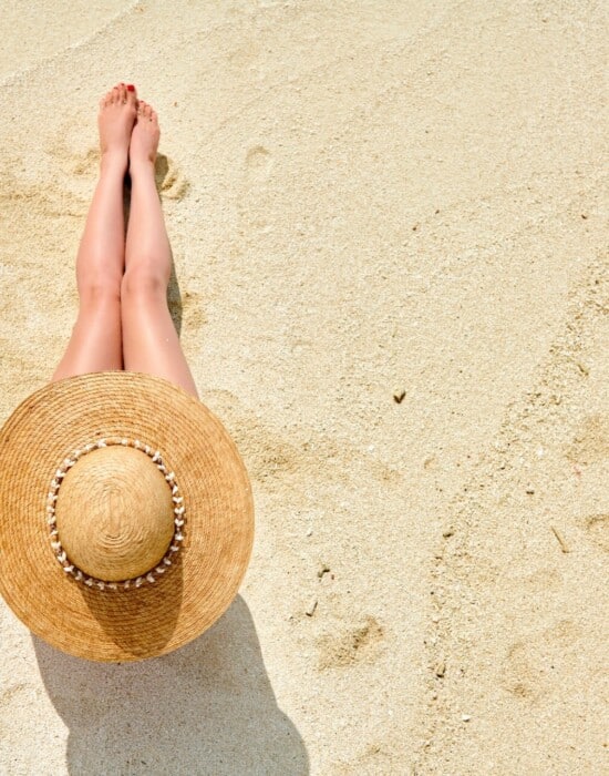 Woman sitting on beach view from above